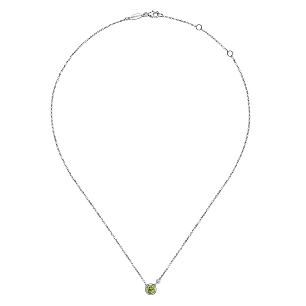 The elegant 925 Sterling Silver Peridot and Diamond Pendant Necklace from the Gabriel & Co Lusso Color Collection features a single, small green gemstone at its center. The fine chain is made of 925 sterling silver and includes an adjustable length with several small loops near the clasp.