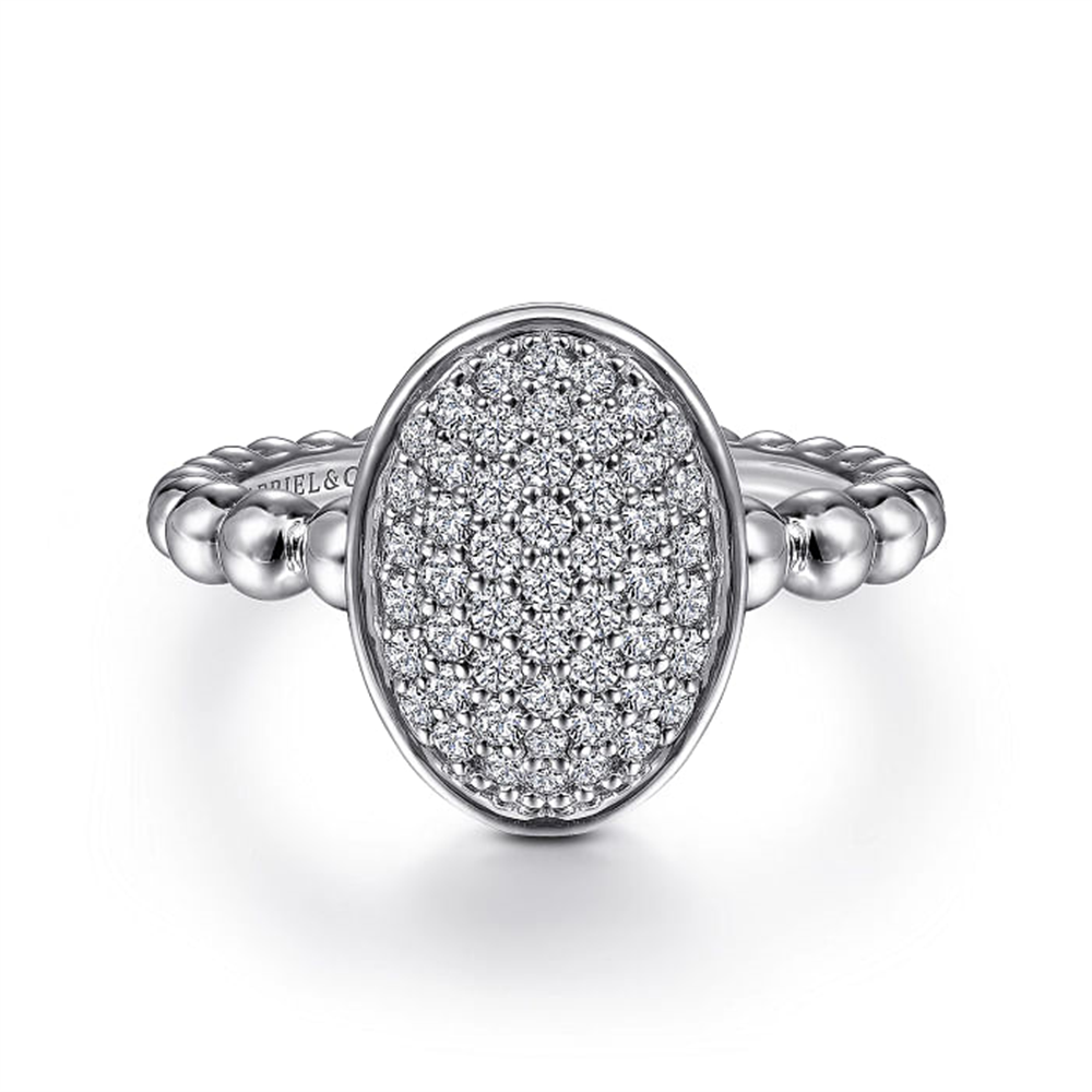 A stunning 925 Sterling Silver Oval Signet Ring with White Sapphire Pavé from the luxurious Bujukan Collection by Gabriel & Co showcases an oval-shaped setting encrusted with numerous small, sparkling white sapphires, featuring an elegant and timeless design.