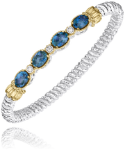 The Alwand Vahan Jewelry 4mm LBT closed band bracelet features four 7x5mm oval blue gemstones and three round diamonds set in textured sterling silver, accented with 14k gold around the stones.