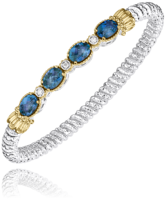 The Alwand Vahan Jewelry 4mm LBT closed band bracelet features four 7x5mm oval blue gemstones and three round diamonds set in textured sterling silver, accented with 14k gold around the stones.