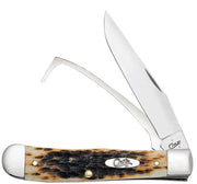 An equestrian's knife, the Amber Bone Peach Seed Jig Equestrian Knife (Case 00144) by W.R. Case & Sons Cutlery Co., features a distinctive stag-patterned Amber Bone handle. It comes with two blades: one standard and one hook-like, both in the open position. The handle is embellished with a silver bolster and a centered logo, ensuring it is as stylish as it is functional.