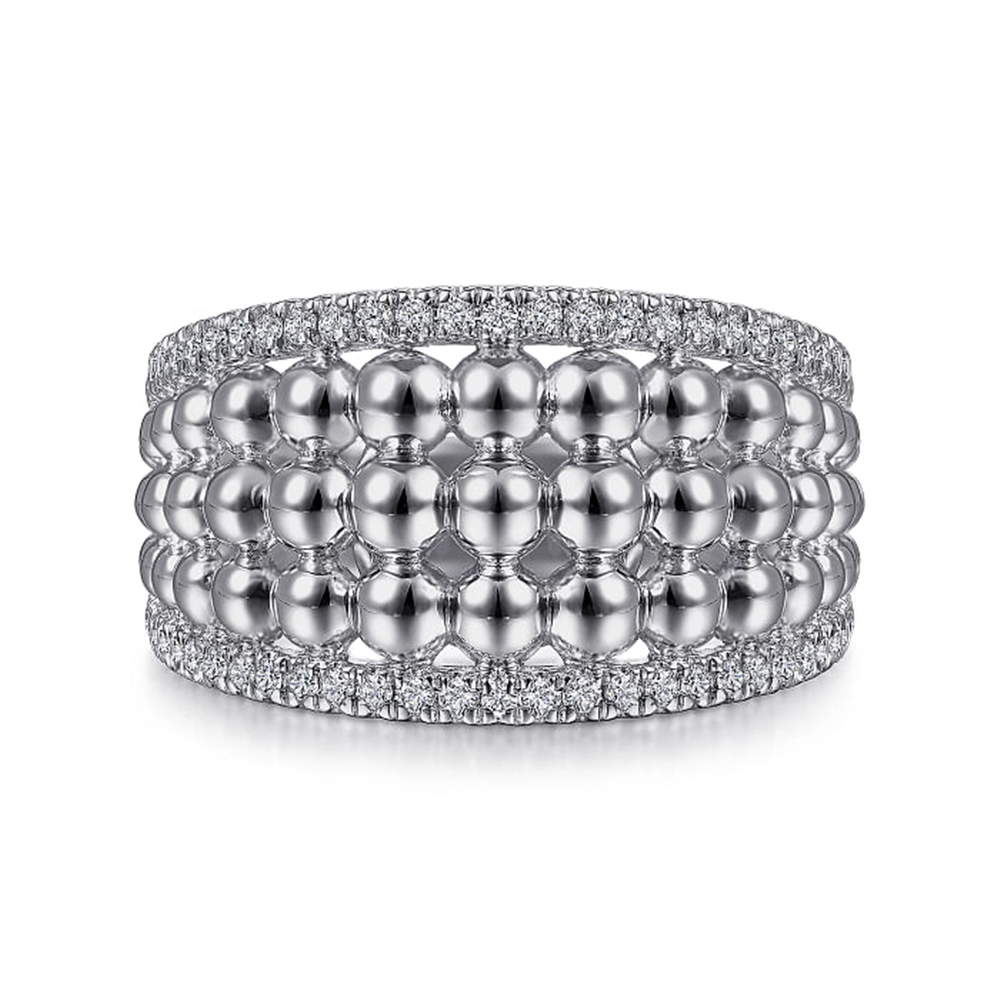 This Gabriel & Co Bujukan Collection piece, the 925 Sterling Silver White Sapphire Wide Bujukan Ring, features a luxurious design adorned with three rows of polished spherical beads. It's elegantly flanked by two rows of small, glittering diamonds on the top and bottom edges, with an added touch of white sapphires for extra sparkle.