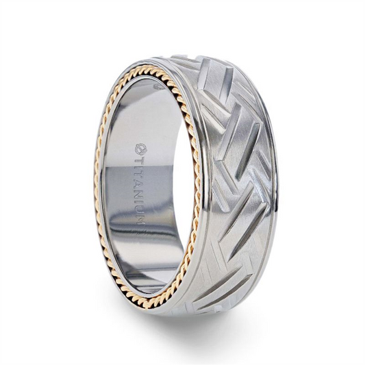 The SATURN Woven Pattern Titanium Ring by Thorsten features a detailed tire tread design in silver titanium, complemented by a gold rope-like inner edge. The interior is smooth and engraved with "TITANIUM". This 8mm ring masterfully combines rugged elements with refined craftsmanship for a truly unique appearance.