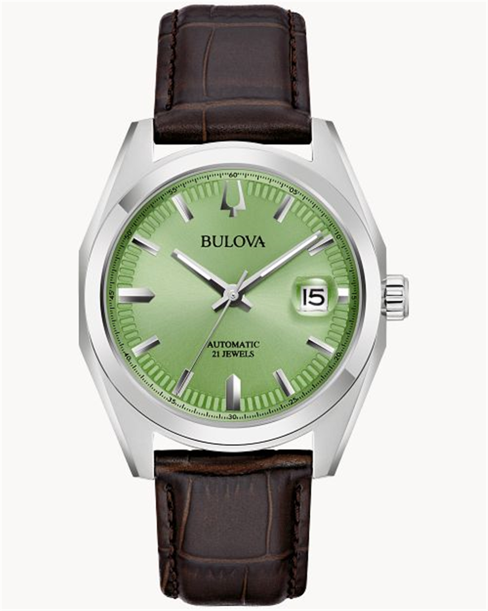 The Survey M Y ST GN Auto by Bulova Watch Company is a silver wristwatch featuring a light green dial, silver hour markers, and a date display at the 3 o'clock position. It boasts an automatic 21 jewels movement and is paired with a dark brown leather strap.