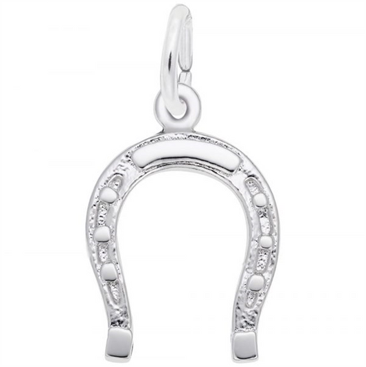 The SS-Horseshoe charm by Rembrandt Charms, a gleaming silver pendant with intricate engravings, hangs beautifully from a loop. The horseshoe is oriented with the open end facing downwards and stands out strikingly against the plain white background.