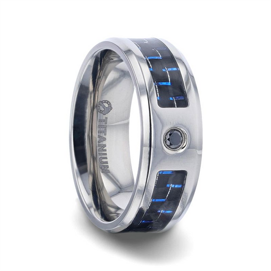 The PACIFIC - Black and Blue Carbon Fiber Inlaid Titanium ring by Thorsten showcases a contemporary design with black and blue carbon fiber inlay on its band. This striking silver titanium ring features a glossy finish and a set small black gemstone. The word "Titanium" is engraved inside the band, echoing its PACIFIC-inspired elegance.