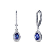 Introducing the Leverback Halo Drop Earrings by Lafonn: a pair of elegant teardrop-shaped earrings featuring deep blue gemstones at the center, surrounded by small clear crystals and set in either a sterling silver or white gold frame. The upper part showcases a curved design encrusted with additional clear crystals, making these timeless classics truly shine.
