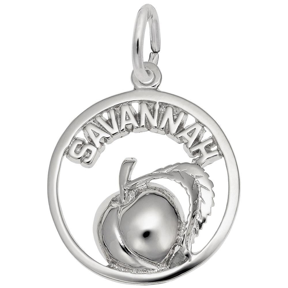 The Savannah Peach Charm by Rembrandt Charms is a sterling silver pendant with the word "SAVANNAH" at the top, elegantly highlighting a raised peach with a leaf centered within its circular frame.