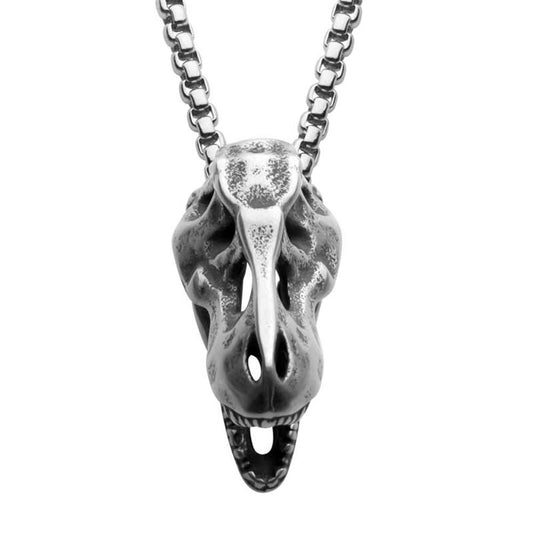 The INOX Distressed Matte Steel T-Rex Skull Pendant, meticulously designed to resemble bones with visible teeth and eye sockets, hangs from a 24" linked chain. This striking silver necklace is prominently displayed against a plain background.