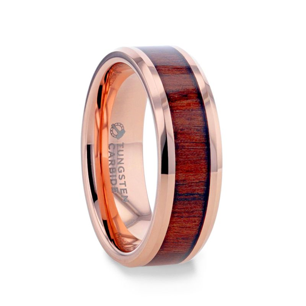The DYLAN Rose Gold Plated Koa Wood Inlaid Tungsten Men's Wedding Band by Thorsten features a polished rose gold-plated finish and a dark koa wood inlay. The interior of the ring is engraved with the words "TUNGSTEN CARBIDE.