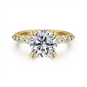 The Gabriel & Co 14K yellow diamond engagement ring (SN: S207933) features a 7.4mm round centerpiece accented by smaller diamonds on the band. Available in size 6.5.