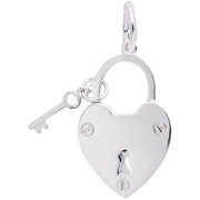 The "Locked With Love Charm / Sterl" by Rembrandt Charms is a sterling silver, heart-shaped padlock accompanied by a matching key, connected by a small ring at the top. The padlock features a keyhole in the center and two screws near the bottom, showcasing a design that is both simple and elegant.