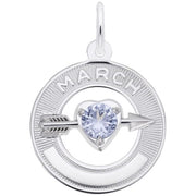 The Rembrandt Charms March Love Birthstone Charm, made of sterling silver, features a circular design with "MARCH" engraved at the top. Within the circle lies a heart-shaped gem in an aquamarine hue, pierced by a silver arrow. The pendant's outer edge has a textured pattern that exudes elegance.