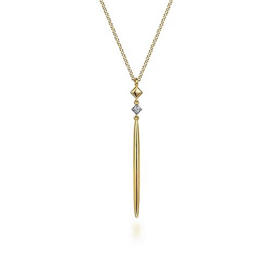 The 14K Yellow Gold Diamond Pendant Drop Necklace by Gabriel & Co features a long, slender diamond pendant in 14K yellow gold, accented with a small geometric gold shape above it. The pendant gracefully hangs from a delicate gold chain, epitomizing an elegant and minimalist modern design aesthetic.