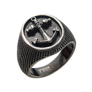 The Men's Stainless Steel Antique Finished with Anchor and Skull Signet Ring by INOX features a textured band and a circular face adorned with a raised anchor design. The anchor is intricately detailed with a chain wrapped around its shaft, and the brand name "INOX" is engraved at the base of the band.