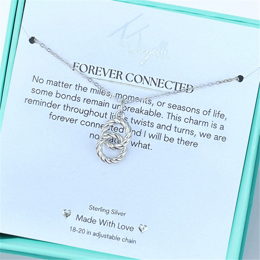 The Forever Connected Sterling Silver Charm Necklace by T Jazelle features a twisted knot pendant in a blue box with a card reading: "FOREVER CONNECTED. No matter the miles...we are forever connected." Adjustable chain included.