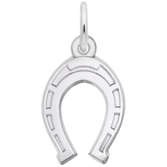 A Rembrandt Charms sterling silver Horseshoe Charm, intricately engraved and hanging from a small loop at the top, stands out against a plain white background, showcasing its polished surface and detailed design.
