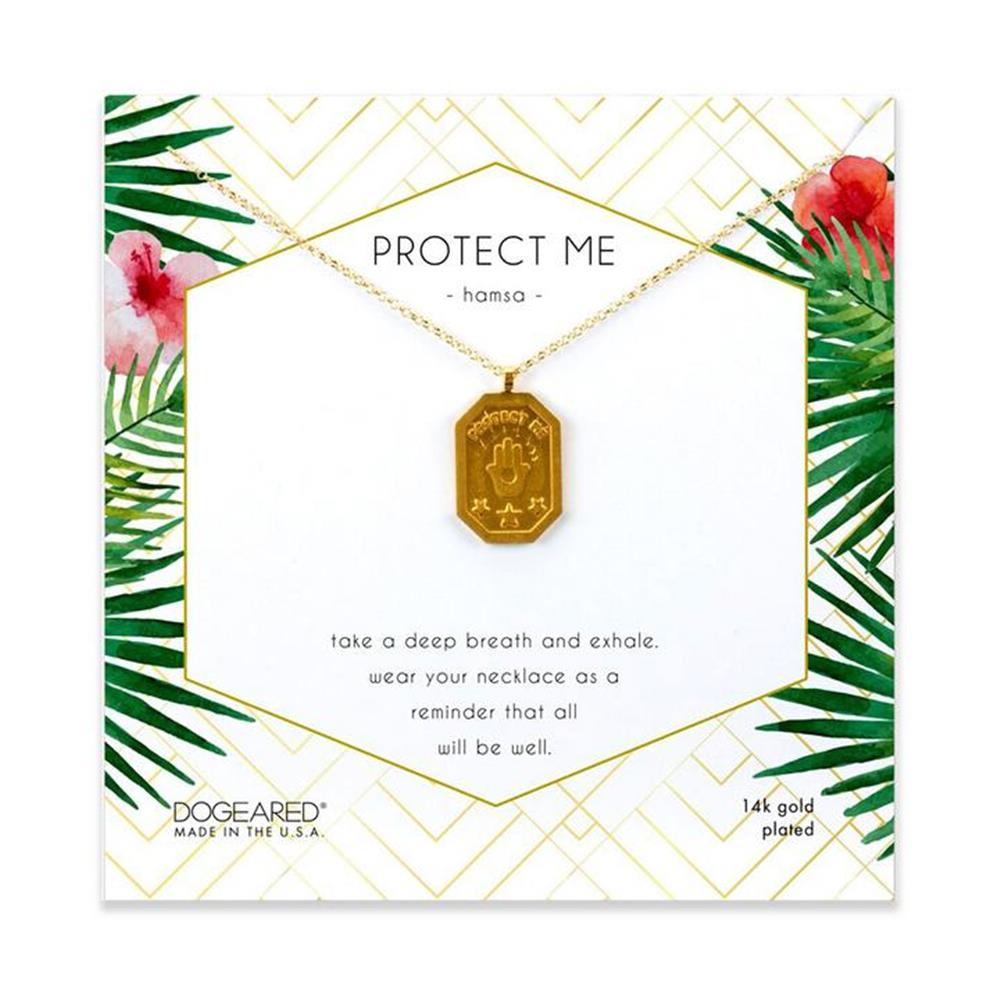 A gold necklace with a rectangular pendant featuring the Protect Me Hamsa symbol, from Dogeared's "Protect Me Hamsa / GP-SS" collection, is displayed on a card adorned with green geometric and floral designs. The card includes the words "Protect Me" and "Wear your necklace as a reminder that all will be well," along with product details like GP-SS.