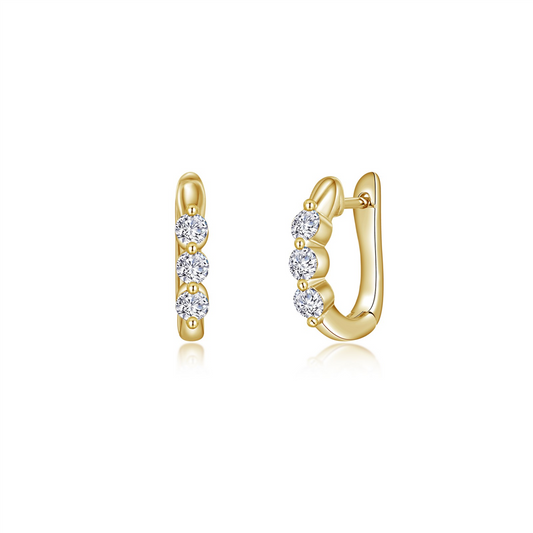 A pair of elegant gold hoop earrings, reminiscent of Lafonn's GP 3 stone huggies, adorned with three evenly spaced round diamonds on each earring. The diamonds are set vertically along the outer edge, adding a touch of sparkle to the polished gold hoops. The earrings have a secure hinge closure.