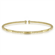 This 14K Yellow Gold Bujukan Open Bangle from Gabriel & Co features a slim, open design with small round gold beads alternating with smooth, elongated gold bars. The ends are capped with slightly larger round beads, and it boasts a shiny, polished finish.
