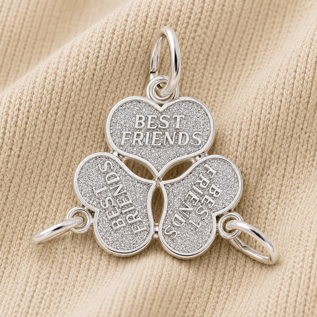 Show your three-way friendship with the Rembrandt Charms Three Best Friends Charm—crafted in sterling silver, this set features three distinct heart pieces engraved with “BEST FRIENDS.” When placed together on a beige fabric background, they unite to form a complete break-apart heart necklace set—a perfect symbol of your lasting bond.