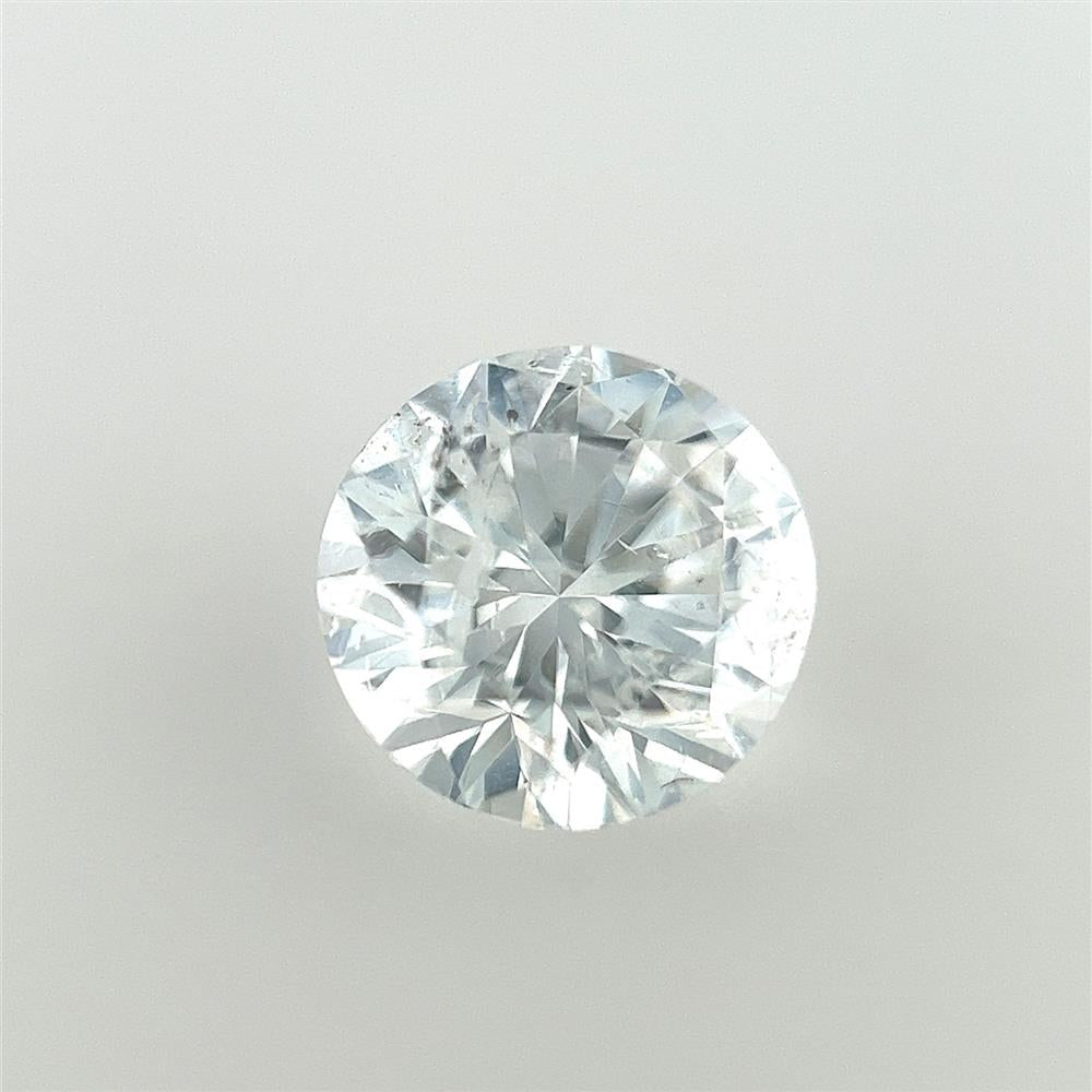 A Natural Diamond Brilliant Round from Cedar Trading, Inc. is set against a plain, neutral background. This 1.01-carat diamond, with a clarity grade of SI 2 and a color grade of G, displays exceptional clarity and sparkle with its intricate facets reflecting light beautifully.