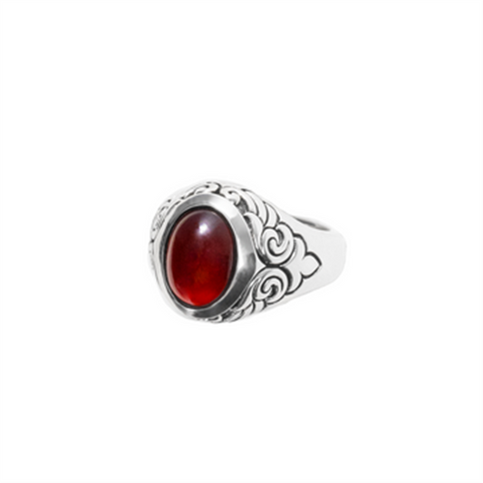 The King Baby Garnet Oval Stone Ring W/ Wing Detail features ornate floral engravings, wing accents, and a large oval red garnet at its center, shown against a plain white background.