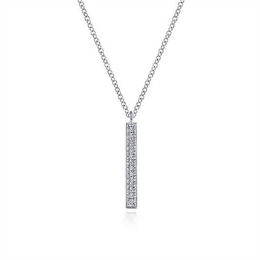 Introducing the Gabriel & Co 14K White Gold Diamond Bar Pendant Necklace, a timeless piece from our Lusso Collection. This exquisite necklace features a silver vertical bar adorned with small diamonds and is paired with a delicate chain that enhances its elegant simplicity. The minimalist design beautifully showcases the sparkling diamonds, making it a perfect addition to any jewelry collection.