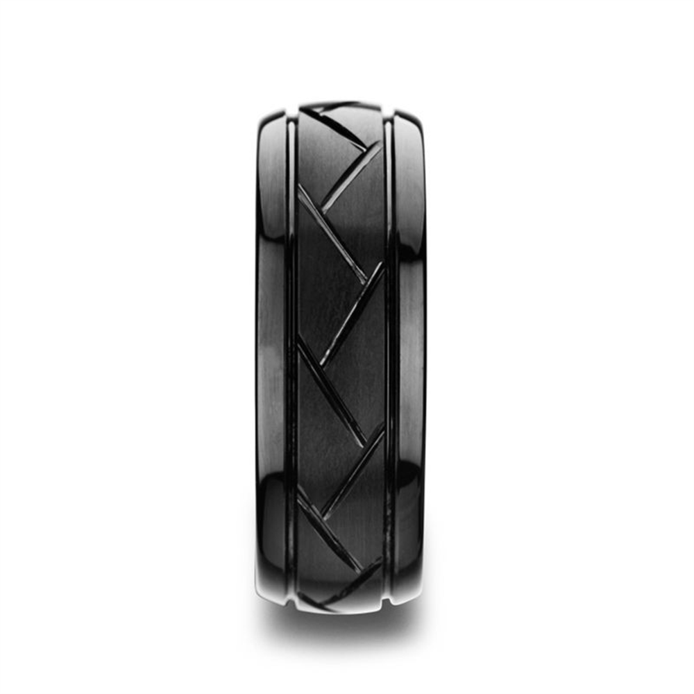 The ENIGMA Domed Black Tungsten Ring by Thorsten features a matte brushed finish and an intricate pattern of alternating diagonal cuts around its band. The modern design contrasts subtly with the polished edges of this 8mm wedding band, creating a sleek and contemporary look. The white background enhances the ring's detailed craftsmanship, making it truly stand out. Available in size 10.