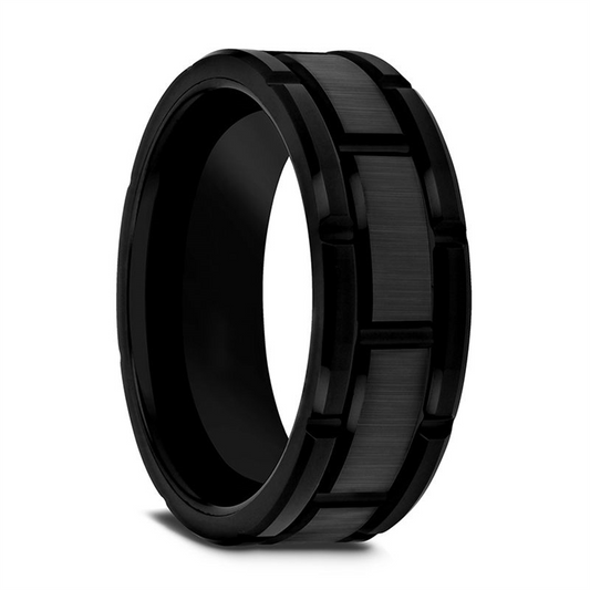 The WINDSOR Beveled Black Tungsten Carbide Wedding Band by Thorsten, showcased against a plain white background, features a brushed center stripe and grooved edges. This wedding band offers an industrial, modern design with a sleek and durable appearance.
