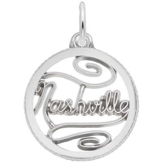 The Rembrandt Charms Nashville Disc Charm in sterling silver features a circular pendant with the word "Nashville" intricately designed in cursive inside, complete with a loop at the top for attaching to a chain.