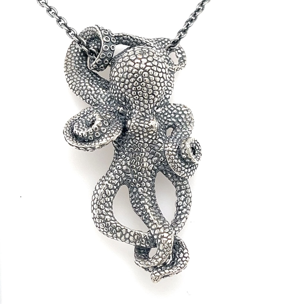 The Kabana SS Octopus Pendant with oxidized silver features detailed, textured tentacles and hangs from a 22-inch chain for a striking look.