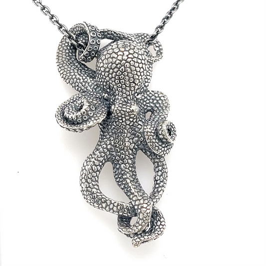 The Kabana SS Octopus Pendant with oxidized silver features detailed, textured tentacles and hangs from a 22-inch chain for a striking look.