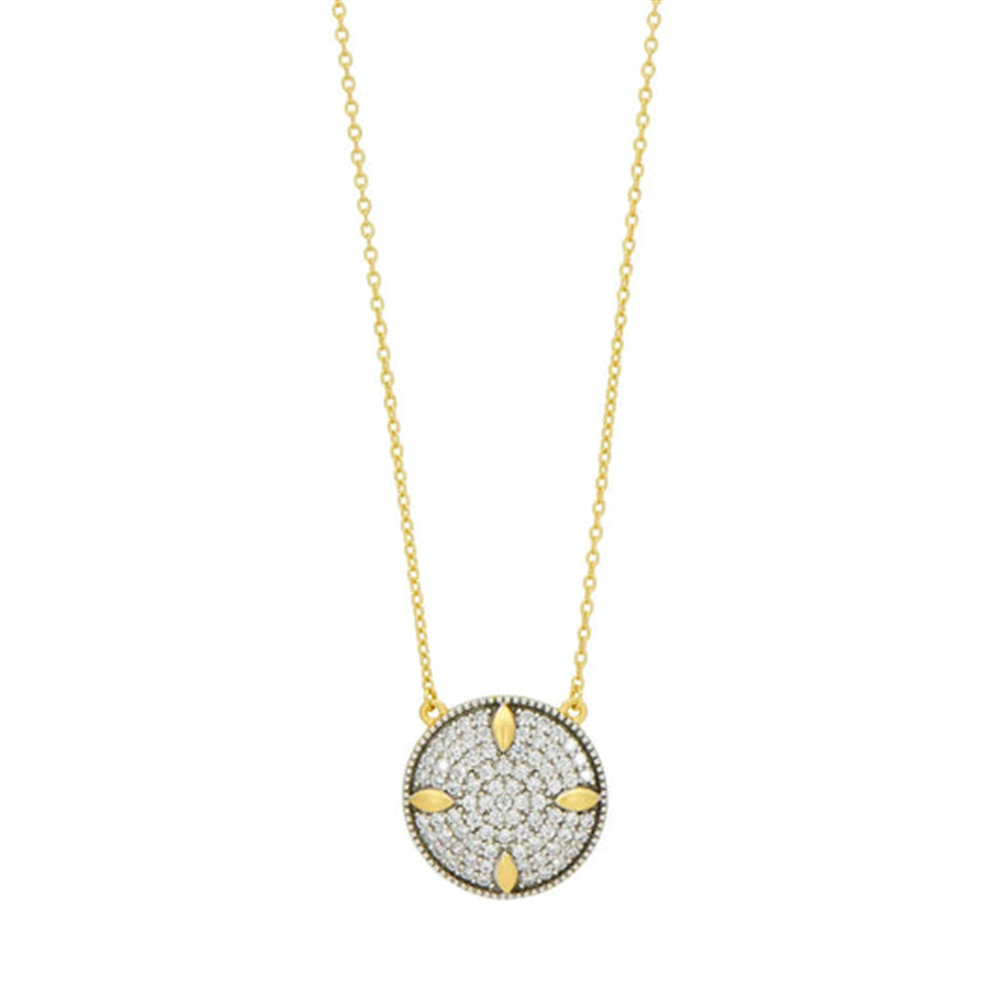 The Freida Rothman Petals and Pavé Small Pendant Necklace, with its delicate chain and pavé accents, captures the elegance of the Brooklyn Skyline through a round gold pendant adorned with small sparkling stones and petal-like arrangements.