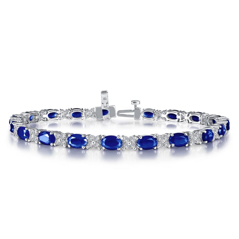 A Lafonn Classic Alternating Bracelet adorned with alternating blue gemstones and clear crystals. This sterling silver piece from Lafonn is finely detailed, with each blue gemstone set in an oval shape, surrounded by the sparkling clear crystals, creating an elegant and luxurious design.