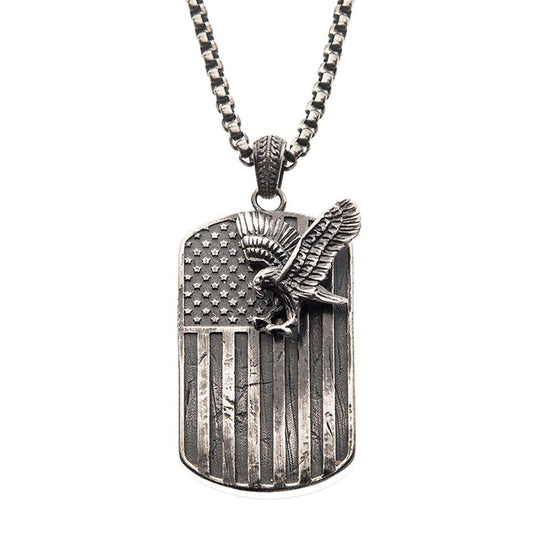 The Gun Metal Plated Rugged American Flag with a Polished Steel 3D Eagle Pendant on a Box Chain by INOX is a striking men's necklace perfect for any occasion. Featuring a rectangular dog tag design, the pendant showcases an American flag with a three-dimensional eagle perched on the stars and wings outstretched. The chain comprises small, interlocking square links, adding to its bold and distinctive look.