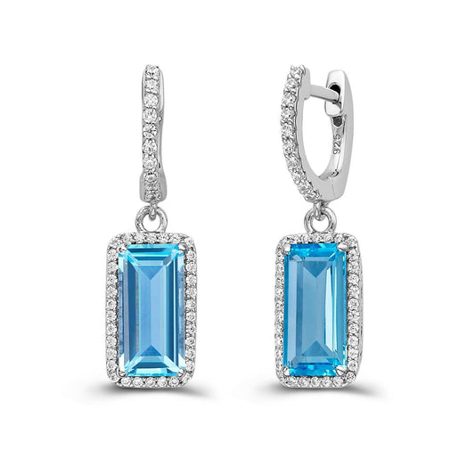 The Blue Topaz Halo Earrings by Lafonn are a stunning pair of silver drop earrings that showcase emerald-cut blue topaz gemstones, encircled by a halo of Lassaire simulated diamonds. The hoop design at the top is embellished with additional small white crystals for extra sparkle and elegance.