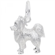 The Rembrandt Charms Papillon Dog Charm in sterling silver depicts a small dog with long, textured fur. The charm features a loop at the top for easy attachment to a bracelet or necklace, and the dog is standing on all four legs, facing sideways.