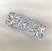 An 8mm wide Gabriel & Co band with a continuous braided and knotted design, displayed on a soft, light-colored background.