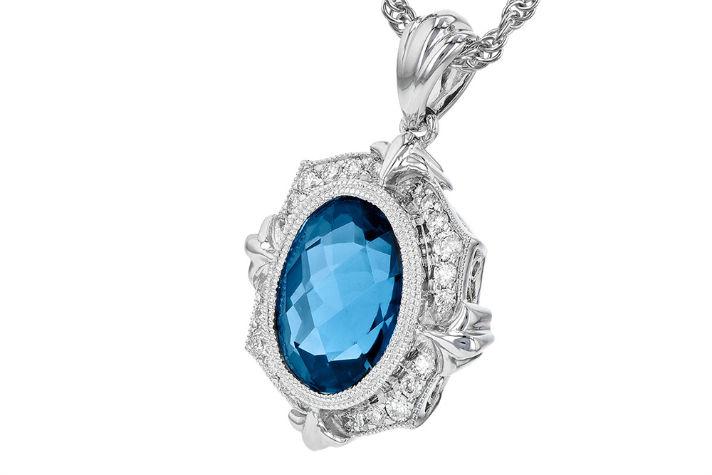 The London Blue Topaz and Diamonds 14K White Gold Necklace by Allison Kaufman showcases a breathtaking oval-shaped London blue topaz pendant encircled by dazzling clear gemstones, all set on an intricately woven chain crafted from 14K white gold, adding a touch of sophistication to this elegant piece.