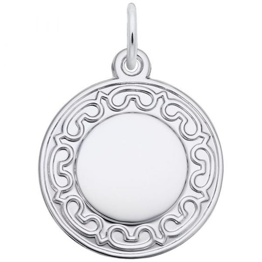 The Disc Charm by Rembrandt Charms features a round, sterling silver pendant with an intricate, decorative border design. The center is smooth and polished, surrounded by a loop for attaching to a chain.