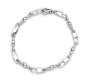 The 5mm width, 7.25-inch length bracelet from Denali Pro Jewelers, named "Fisher of Men," is an elegant piece featuring a swivel lobster clasp fastening. This stylish and modern bracelet combines oval and round links with decorative twists at intervals.
