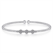 Introducing the 14K White Gold Bujukan Bead and Hexagon Cluster Diamond Bangle by Gabriel & Co. This exquisite bangle features a delicate chain of small, round Bujukan beads and a striking centerpiece adorned with three diamond-studded hexagons. The bracelet is elegantly finished with two rounded bead clasps.