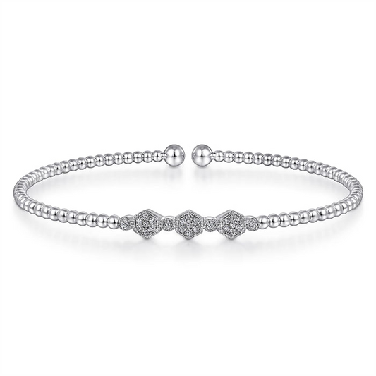 Introducing the 14K White Gold Bujukan Bead and Hexagon Cluster Diamond Bangle by Gabriel & Co. This exquisite bangle features a delicate chain of small, round Bujukan beads and a striking centerpiece adorned with three diamond-studded hexagons. The bracelet is elegantly finished with two rounded bead clasps.