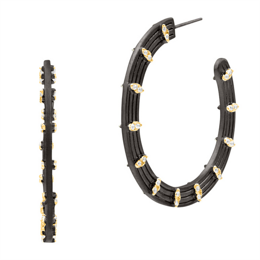 The Freida Rothman FBYKZE42 Fleur Bloom EMPIRE Circular Statement Hoop Earrings feature black hoops with gold accents and clear teardrop gemstones, shown from side and front views on a white background.