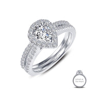 The "Joined-At-The-Heart Wedding Ring" by Lafonn is a stunning engagement piece crafted in silver. It features a prominent pear-shaped central diamond, encircled by a halo of smaller diamonds. The band is elegantly adorned with additional small diamonds for added sparkle. A close-up inset showcases its delicate details labeled "Joined at the Heart." This exquisite wedding ring exudes elegance and brilliance, making it perfect for your special day.