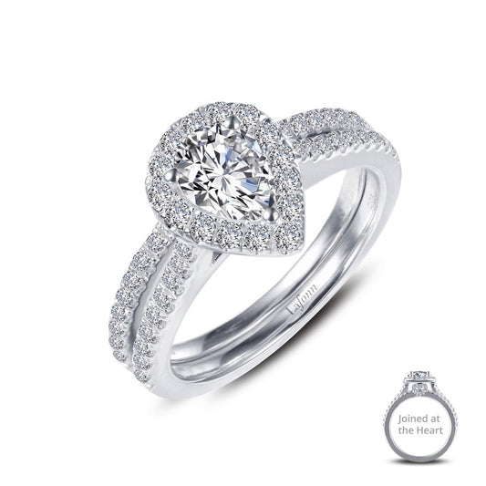 The "Joined-At-The-Heart Wedding Ring" by Lafonn is a stunning engagement piece crafted in silver. It features a prominent pear-shaped central diamond, encircled by a halo of smaller diamonds. The band is elegantly adorned with additional small diamonds for added sparkle. A close-up inset showcases its delicate details labeled "Joined at the Heart." This exquisite wedding ring exudes elegance and brilliance, making it perfect for your special day.