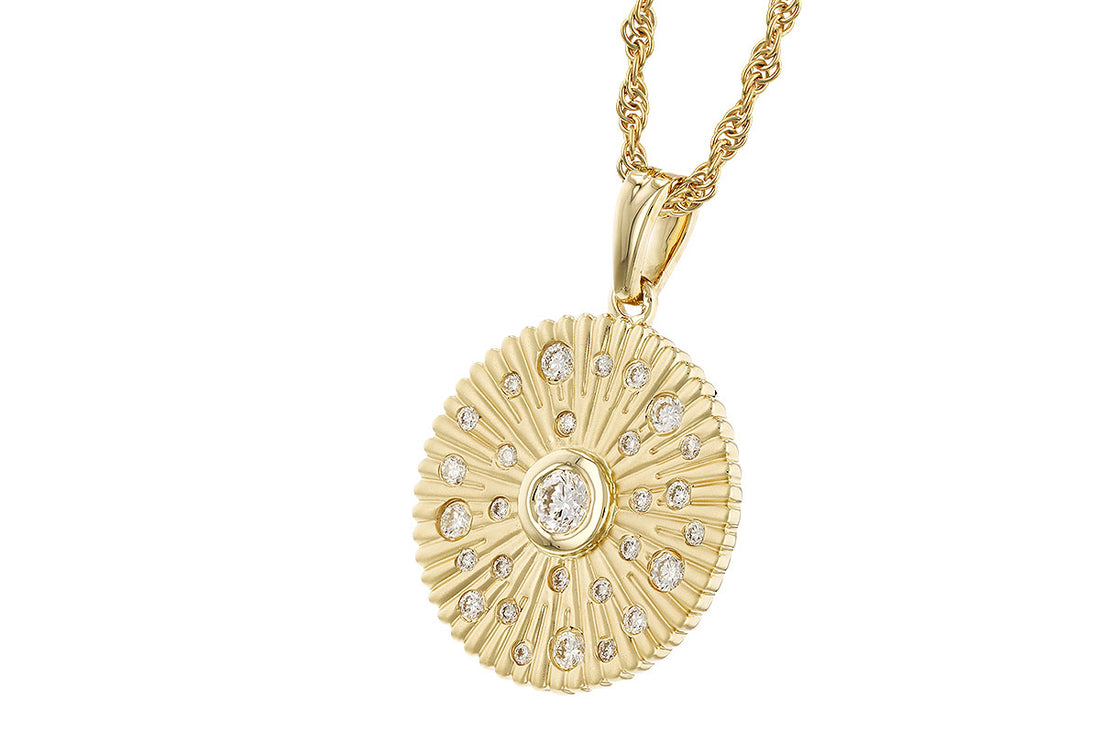 Introducing the Allison Kaufman Diamond 14k Yellow Gold Necklace, featuring a circular pendant with a textured sunburst pattern. This exquisite piece is adorned with small clear diamonds surrounding a larger central diamond, all gracefully suspended from a twisted gold chain.