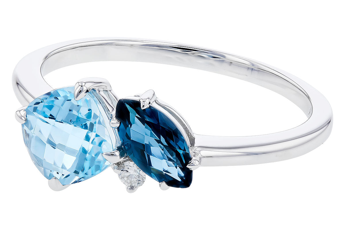 The Allison Kaufman Blue Topaz and Diamond 14k White Gold Ring showcases two faceted blue topaz gems—one light blue oval and one dark blue marquise—set side by side with a diamond accent.