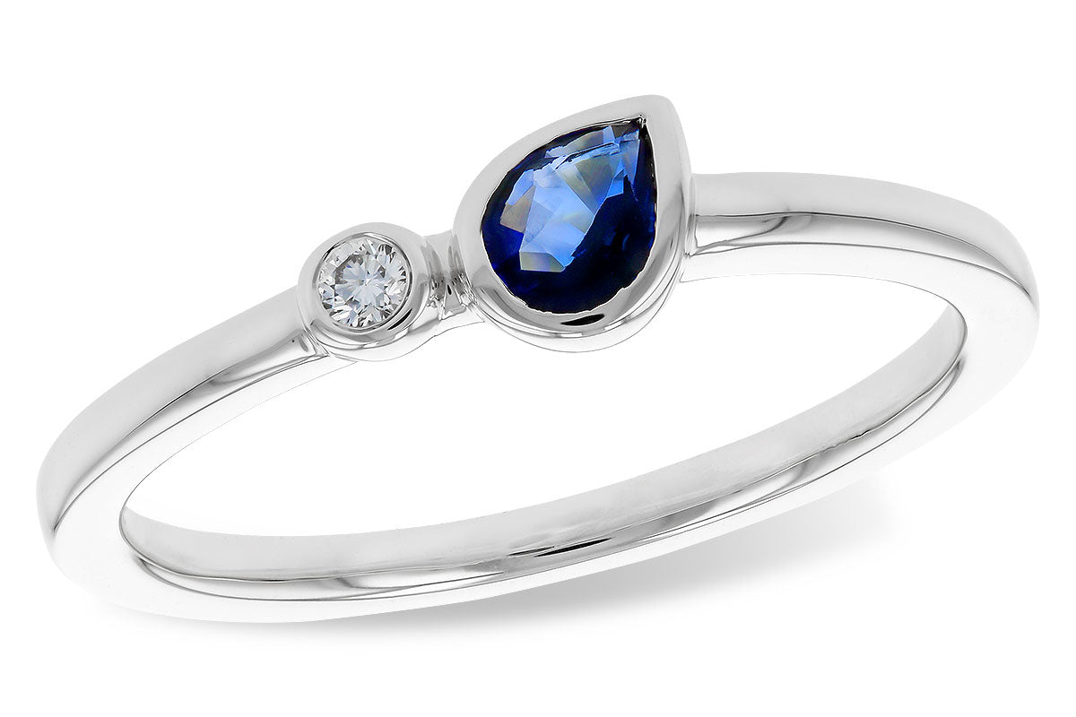 The Allison Kaufman 14k white .26ct sapphire ring features a pear-shaped blue sapphire beside a small round clear stone, both set on a slender, polished band.